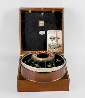 A late 19th century mahogany cased Praxinoscope theatre, the hinged outer box containing original tu