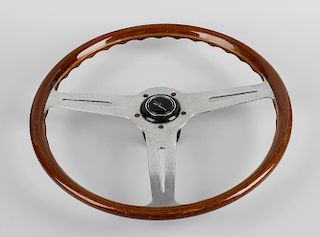 A Les Leston three spoke wooden rimmed steering wheel, each of the flat polished spokes with pierced