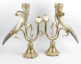 An unusual pair of brass and ox horn table lamps. Each horn with pierced gilt metal collars, on Art
