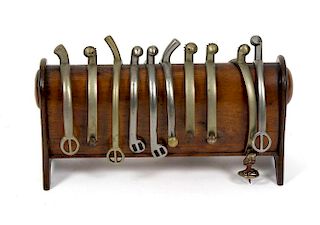 A Victorian mahogany spur standHaving ten spurs (including three pairs), most by Maxwell, on arched