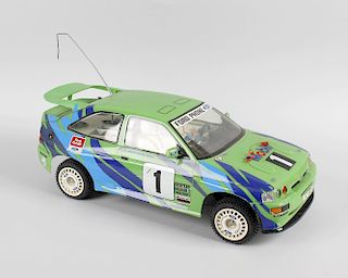 A box containing a Tamiya Ford Escort RS Cosworth radio controlled model car with Acoms hand held co