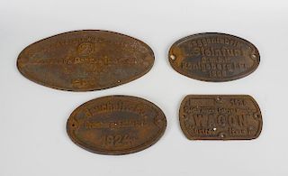 A box containing seven vintage railway wagon cast iron plates, to include an America and German exam