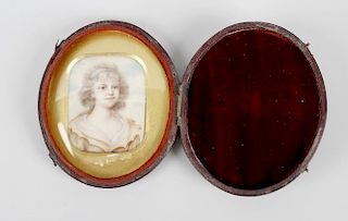 An oblong miniature, depicting a young girl with blue sky back drop, in gilt surround and oval burgu