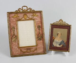 An Empire style silk and gilt metal photo frame, with stylised wreath surmount, the frame with flora