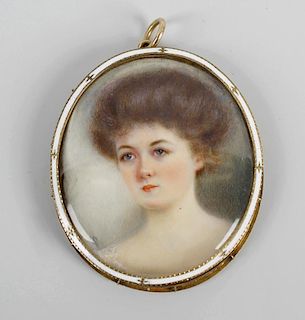An oval miniature depicting a young woman with white enamel and delicate gilt detailed frame surroun