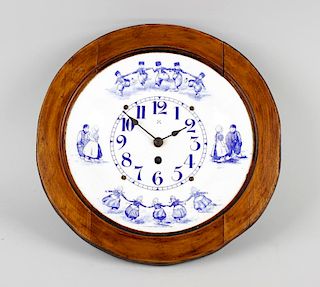 An enamelled wall clock, the dished circular dial having Arabic numerals and decorated with printed