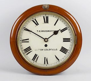 A late 19th century mahogany cased wall clock, the circular case with hinged opening glazed door, en