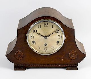 Two oak mantel clocks. Comprising a 'Napoleon's Hat' type example and another similar, each with thr
