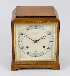 An Elliott walnut mantel clock. Retailed by Camerer Cuss & Co., the 5.5-inch dial having a silvered