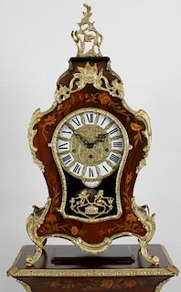A modern Italian clock and pedestal cabinet. The gilt dial having white enamel Roman numerals and ma
