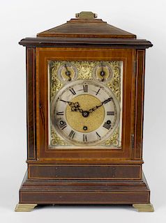 An early 20th century mahogany cased clock, the gilt metal and silvered dial with black Roman numera