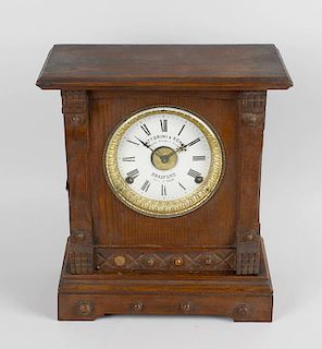 A Fattorini & Sons patent automatic alarm clock in stained wooden case, an early twentieth century s