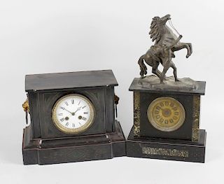 A Victorian black slate cased mantel clock, the case of architectural shaped form, the circular dial