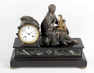 A late 19th century French spelter and black marble mantel clock.The 3.5-inch white Roman dial with