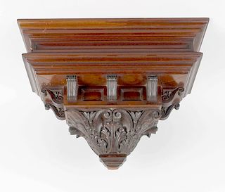 A large Victorian carved mahogany clock bracketThe moulded rectangular top over fielded panelled fri