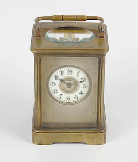 A late 19th century brass-cased carriage clock.Having a 2-inch cream Arabic chapter ring with brass