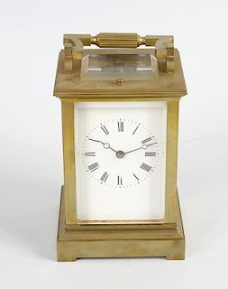 A late 19th century brass cased carriage clock, the white enamelled dial with black Roman hours, div