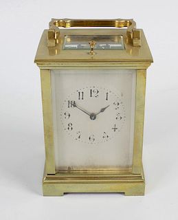 A late 19th century brass cased carriage clock, the silvered dial with black Arabic hours, divisions