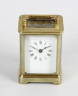 A late 19th century brass cased carriage clock style time piece with alarm, the white enamelled dial