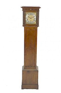 An early 20th century oak-cased chiming grandmother clockHamburg American Clock CompanyThe 8-inch sq