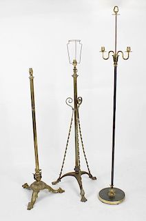 Three standard lamps. The first with tubular stem and twisted scroll supports on tripod base, plus a