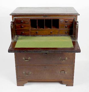 An early 19th century mahogany secretaire chest of drawers. The rectangular top over a fall-front dr