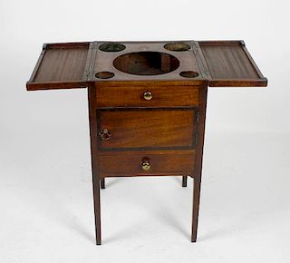 An early 19th century mahogany square washstand. The hinged chequer-strung two-piece top enclosing c