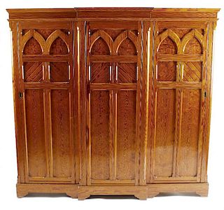 A Victorian gothic revival pitch pine hall wardrobeOf breakfront form with moulded cornice over thre