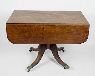 An early 19th century mahogany pedestal Pembroke table. The rectangular top on rounded oblong flaps