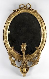 A 19th century gilt wood gesso girandole wall mirror, the later bevelled oval mirror plate within ov