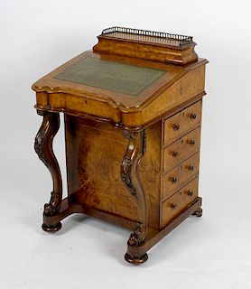 A mid Victorian inlaid walnut Davenport, the hinged superstructure with arcaded brass gallery, enclo