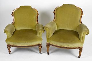 A pair of late Victorian inlaid fruitwood armchairs for a lady and gentleman, having a partially ove
