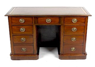 A mahogany twin pedestal kneehole desk, the skiver inset rectangular top, over two columns of four g