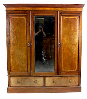 An Edwardian inlaid mahogany triple wardrobe. The central mirrored door flanked by two further havin