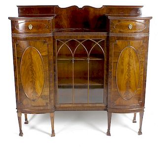 An early 20th century mahogany side cabinet, the raised shaped back above a front fitted with a cent