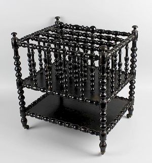 An unusual Regency ebonised canterburyEarly 19th century, of four divisions with bobbin-turned frame