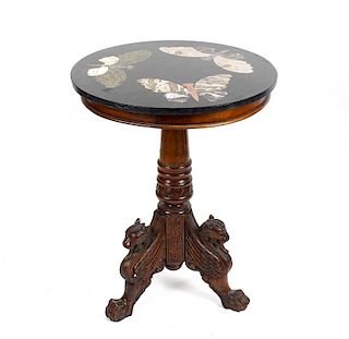 A carved mahogany table with inlaid marble top, the circular top, with pietra dura inlaid butterflie