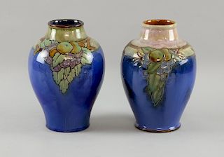 A pair of Doulton blue glazed vases decorated with fruit, Doulton Lambeth marks,  height 21.5 cm