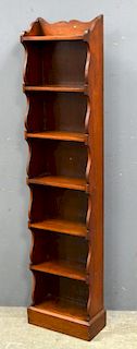 Early 20th century walnut bookcase, height 142, width 32, depth 15 cm.