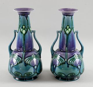 A pair of Minton Secessionist twin-handled vases, in blues and mauve marked to underside Minton prin