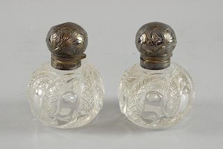 Two cut glass scent bottles, the silver tops with  Art Nouveau chased decoration, Sheffield 1902/4