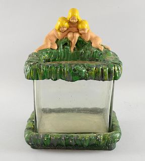 Early 20th century novelty fish tank in painted plaster mount with three children on a bank. Height