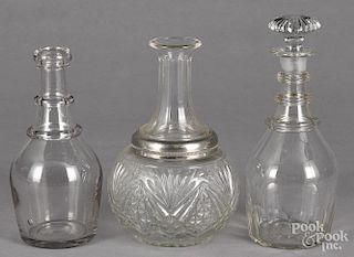 Three colorless glass decanters, 19th c., together with a later decanter with a plated band