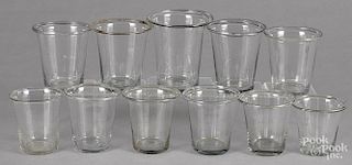 Eleven colorless glass beakers, 19th c., tallest - 4 1/2''.