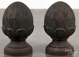 Pair of cast iron pineapple finials, ca. 1900, with remnants of green paint, 15'' h.