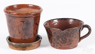 Two pieces of Pennsylvania redware, 19th c., to include a measure with a pour spout, 3 1/4'' h.