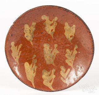 Pennsylvania redware plate, early 19th c., with slip decorated splotches, 8'' dia.