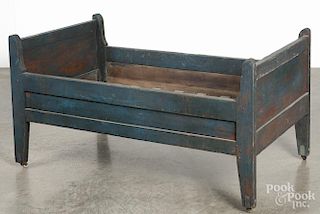 Painted pine youth bed, 19th c., retaining an old blue surface, 24'' h., 47'' l., 27'' w.