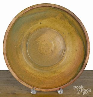 Mid-Atlantic redware centerpiece bowl, 19th c., with yellow and green glaze, 13 5/8'' dia.