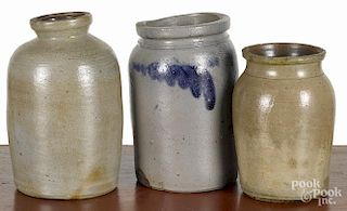 Three Pennsylvania stoneware jars, 19th c., one with cobalt foliate decoration around the shoulder